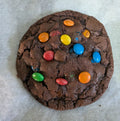 M&M COOKIE:

"M&M cookie topped with colourful M&Ms"
"Handmade chocolate cupcake with M&M candies"